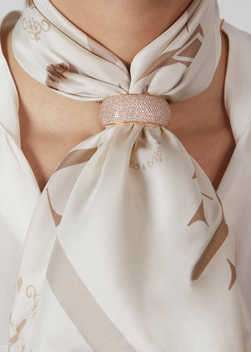 Revolution scarf ring in 18 karat rose gold and diamonds. this scarf ring is crafted in italy from 18 karat rose gold and white round cut diamonds, it features a full diamond pavè design. here worn with beige silk scarf